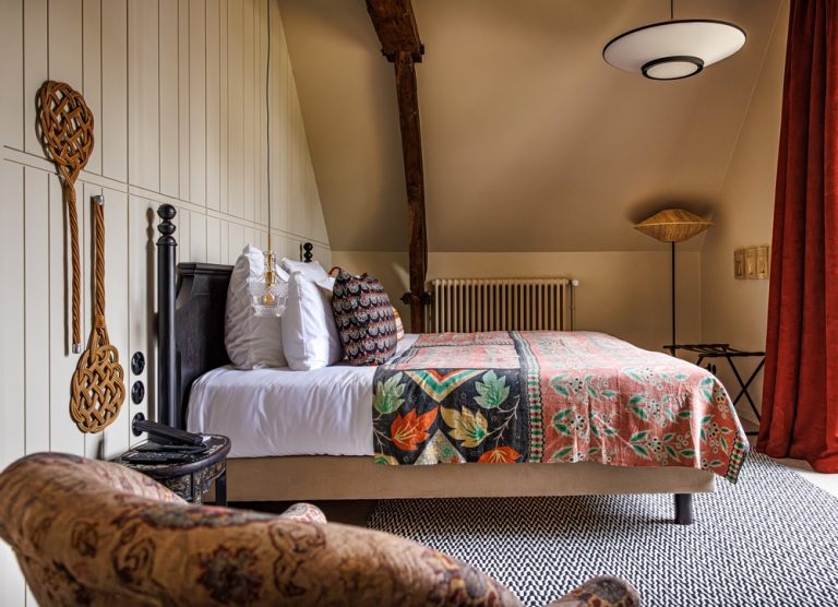 Rustic room with ornate bed, wooden decoration and touches of colour in the cosy park room of our luxury hotel relais et chateau morbihan in bretagne